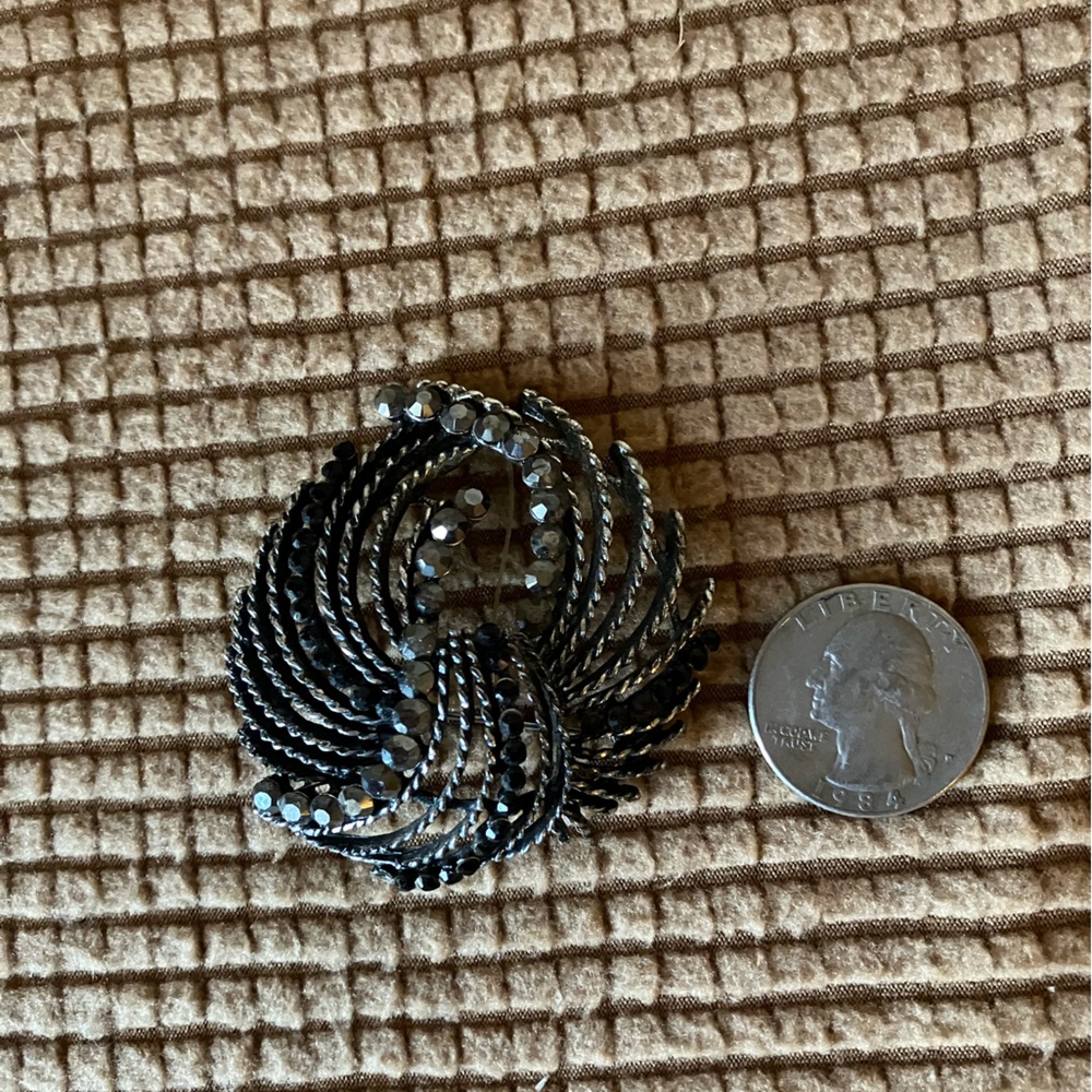 Black and silver brooch.